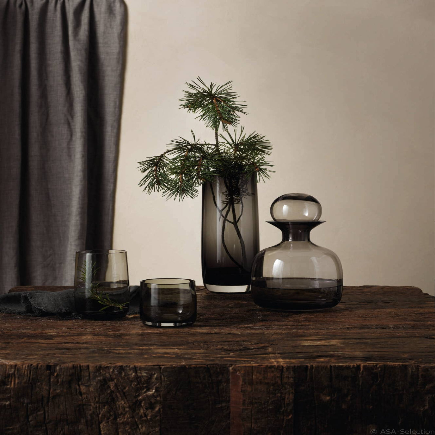 Decorative glassware on a wooden surface with a neutral background